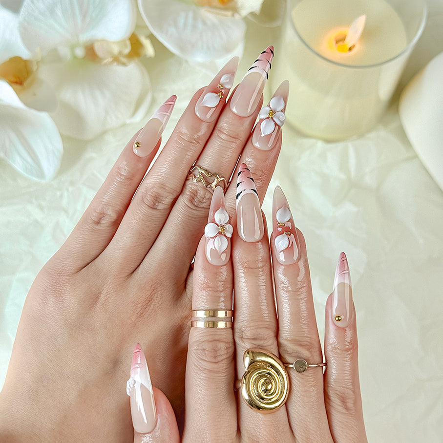 nail art white flowers long stiletto nude red press-on nails with French tip and floral detail