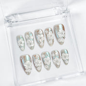 nail art white flowers medium almond blue white press-on nails with metallic luster and 3D floral design
