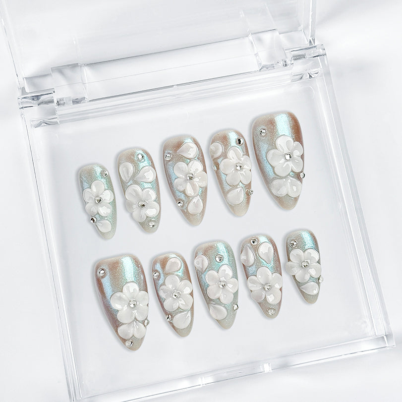 nail art white flowers medium almond blue white press-on nails with metallic luster and 3D floral design