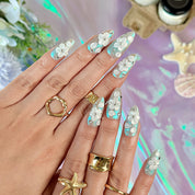 nail art white flowers medium almond blue white press-on nails with metallic luster and 3D floral design