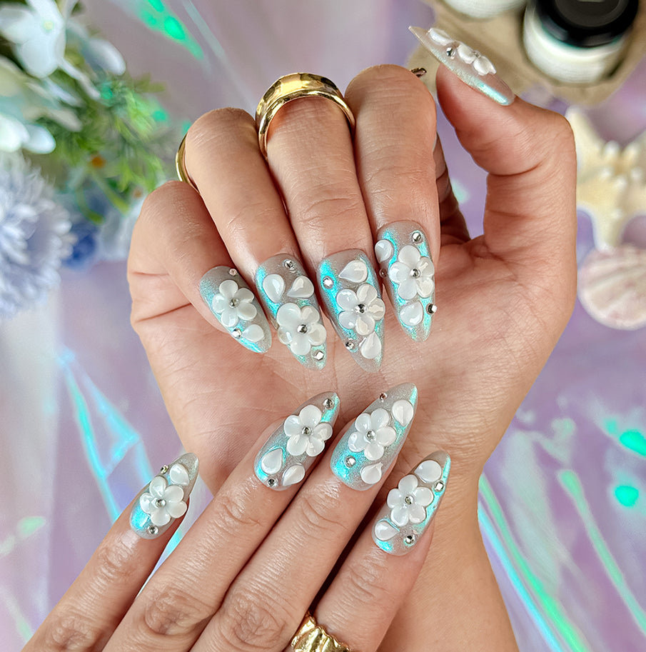 nail art white flowers medium almond blue white press-on nails with metallic luster and 3D floral design
