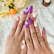 nail designs purple and pink medium almond press-on nails with metallic luster and flower details