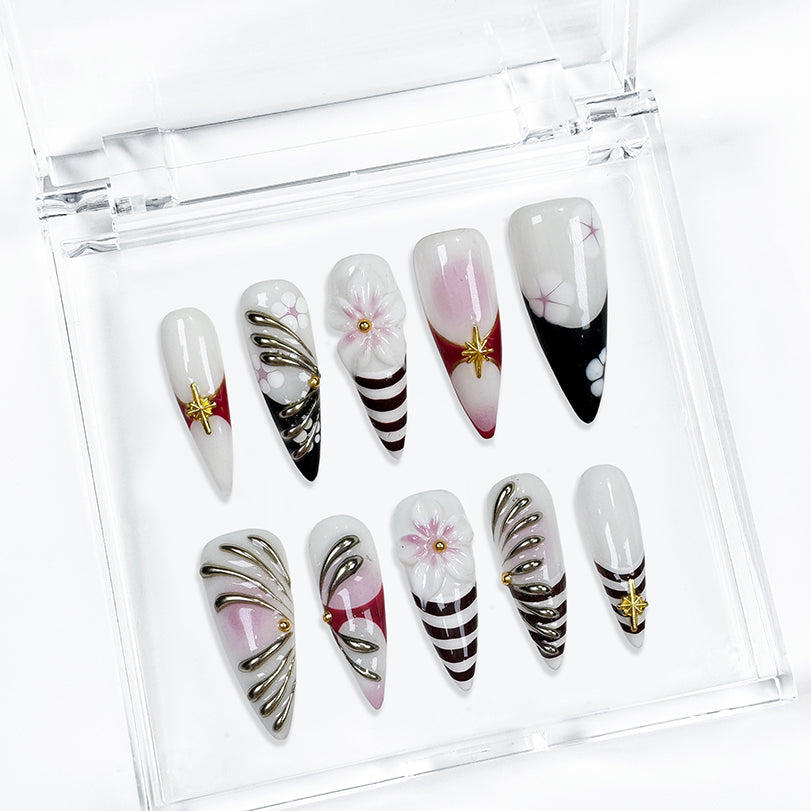 nail designs zebra long stiletto black white press-on nails with flower and metallic holiday details