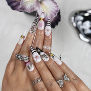 nail designs zebra long stiletto black white press-on nails with flower and metallic holiday details