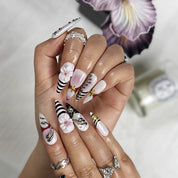 nail designs zebra long stiletto black white press-on nails with flower and metallic holiday details