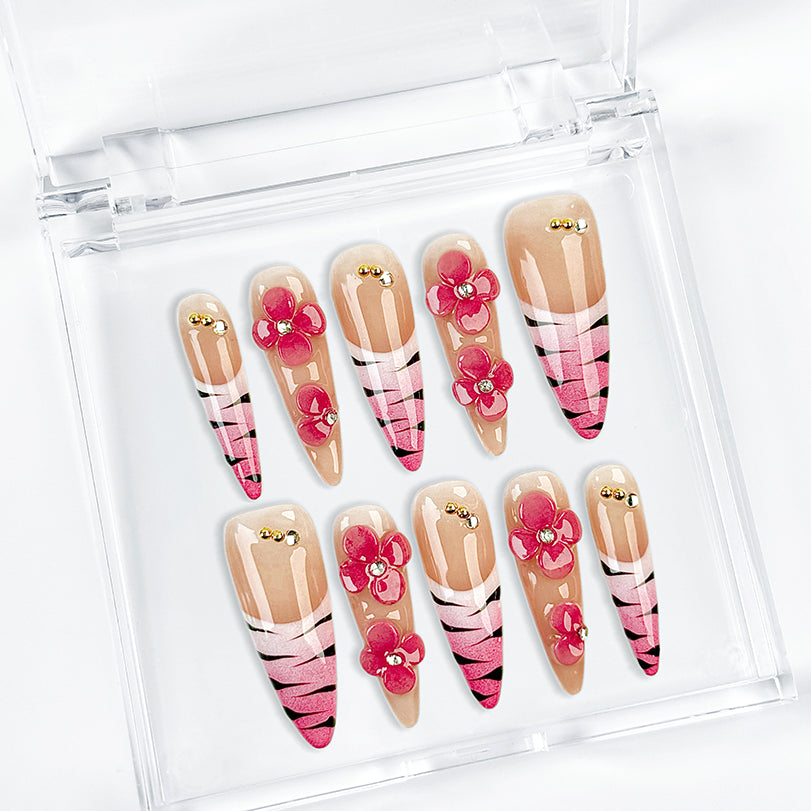 nail designs zebra long stiletto nude pink press-on nails with flower accents and zebra French tip detail