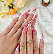 nail designs zebra long stiletto nude pink press-on nails with flower accents and zebra French tip detail