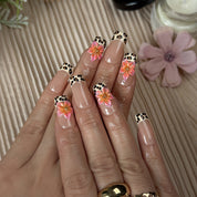 nail designs zebra medium square press-on nails with nude base brown spotted french tips and flower accents simple nail art spring prom style