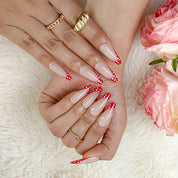 nail designs zebra inspired nude long almond press-on nails with red french tips and white polka dots for summer and prom