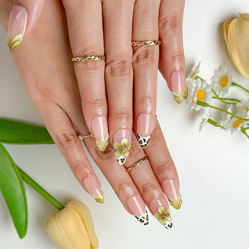 nail designs zebra medium almond nude press-on nails with yellow french tips, leopard-style accents, and 3D flower for summer beach party