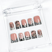 nail designs zebra short square black press-on nails with nude base, zebra print tips, and cute winter holiday accents