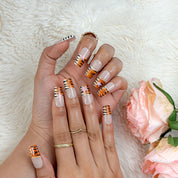 nail designs zebra short square brown press-on nails with nude base and orange black animal stripe tips for fall holiday