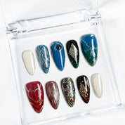 nails blue silver medium almond press-on nails with metallic luster in blue silver and red accents cool winter holiday style