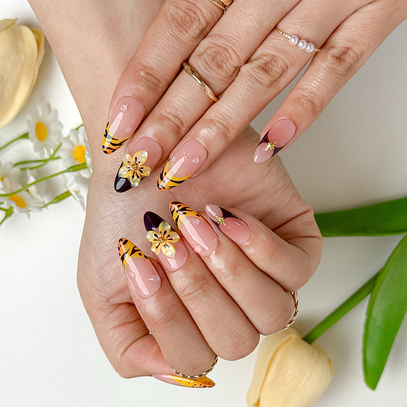 nails orange pink medium almond nude press-on nails with orange French tips and flower detail for summer beach party