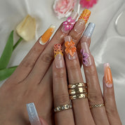 neon orange nail designs long square press-on nails with nude base orange accents and colorful flower details spring beach party style