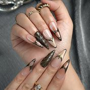 nude brown nails long stiletto press-on nails with brown and black french tips subtle gold accents fall holiday cool style