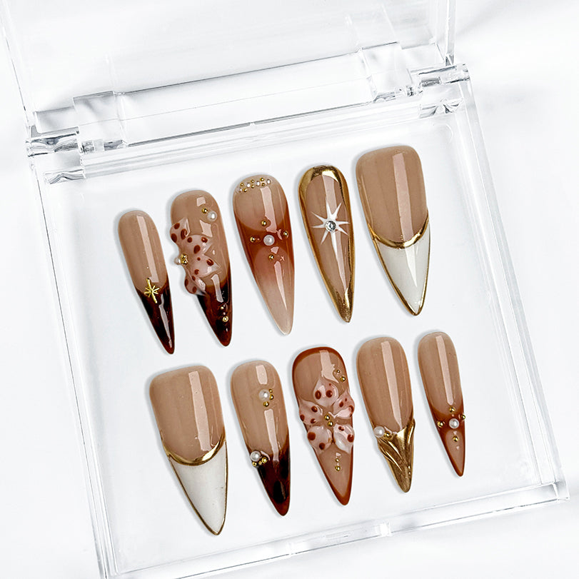 nude nails with flowers long stiletto press-on nails in mocha brown with white french tips floral accents prom fall winter style