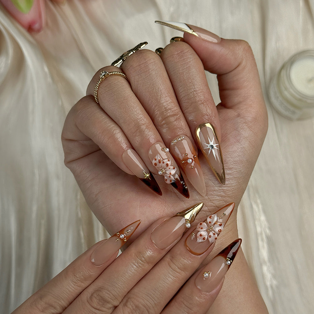 nude nails with flowers long stiletto press-on nails in mocha brown with white french tips floral accents prom fall winter style