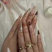 nude nails with flowers long stiletto press-on nails in mocha brown with white french tips floral accents prom fall winter style