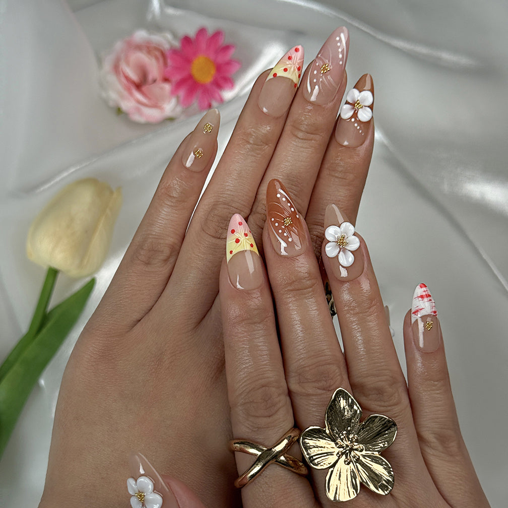 nude nails with flowers medium almond press-on nails in brown nude with 3D white flower accents and gold details for spring wedding beach party style