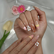 nude nails with flowers medium almond press-on nails in brown nude with 3D white flower accents and gold details for spring wedding beach party style