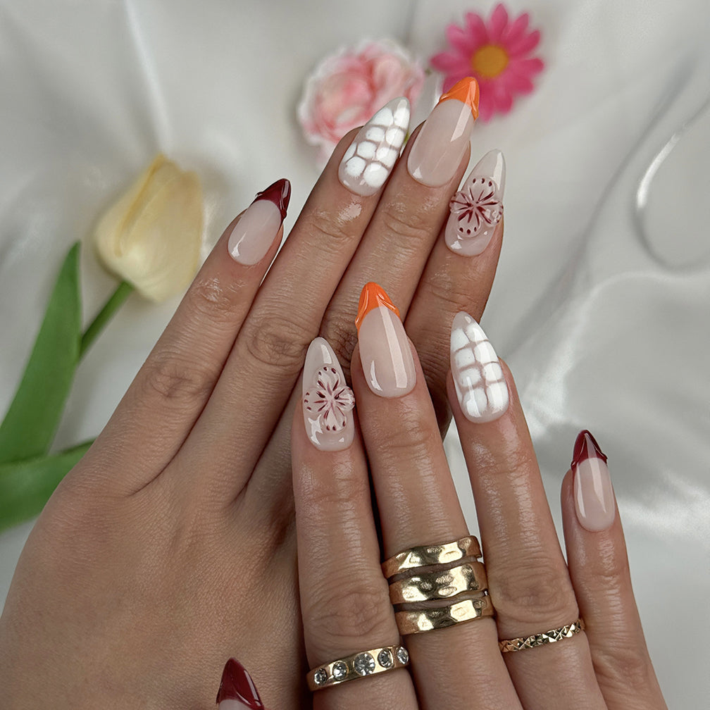 nude nails with flowers medium almond press-on nails with nude base french tips and delicate floral accents summer wedding style