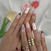 nude nails with flowers medium almond press-on nails with nude base french tips and delicate floral accents summer wedding style