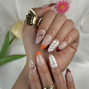 nude nails with flowers medium almond press-on nails with nude base french tips and delicate floral accents summer wedding style