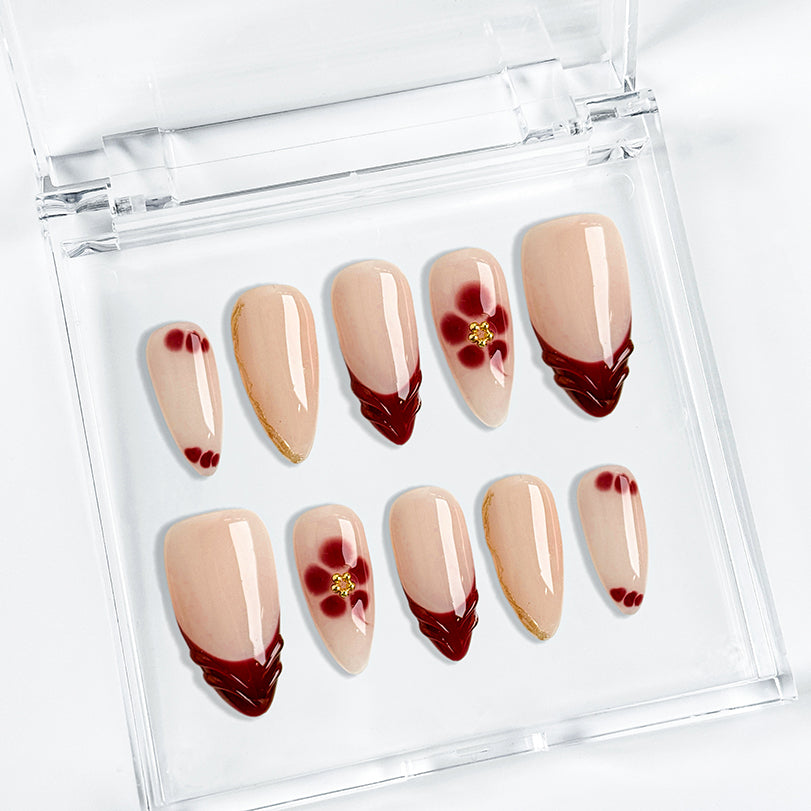 nude nails with flowers medium almond press-on nails with nude base red french tips and floral accent for spring wedding prom style