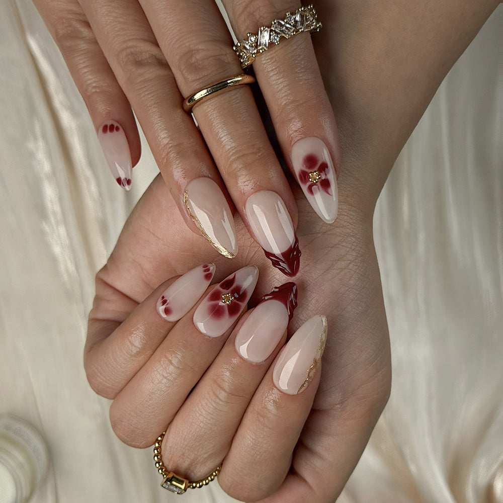 nude nails with flowers medium almond press-on nails with nude base red french tips and floral accent for spring wedding prom style