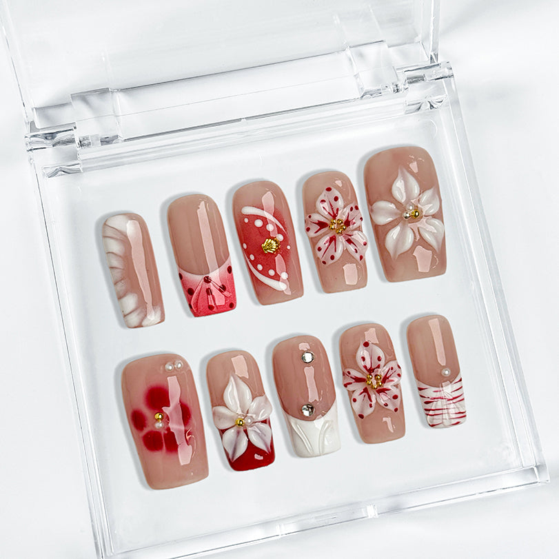nude nails with flowers medium square press-on nails with nude base red floral accents and french tip details spring beach party style
