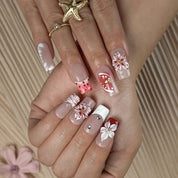 nude nails with flowers medium square press-on nails with nude base red floral accents and french tip details spring beach party style