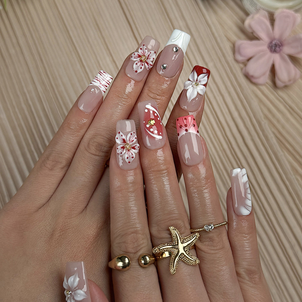 nude nails with flowers medium square press-on nails with nude base red floral accents and french tip details spring beach party style