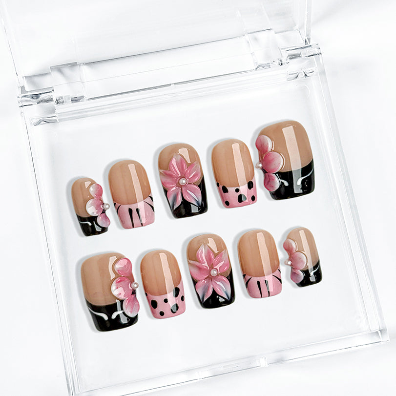 nude nails with flowers short square press-on nails with nude base pink and black french tips cute flower accents spring beach party style