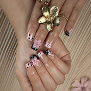 nude nails with flowers short square press-on nails with nude base pink and black french tips cute flower accents spring beach party style