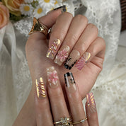 ombre nails stiletto inspired medium square press-on nails with black and pink ombre metallic luster and flower accents prom spring style