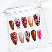 orange nails with designs medium almond press-on nails with pink floral accents and gold metallic highlights for summer and prom