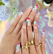 pink and nude nails medium almond press-on nails with blue French tip accents and 3D flower details