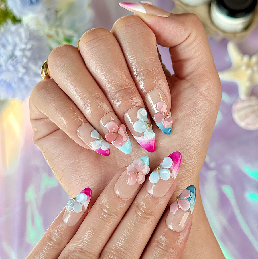 pink and nude nails medium almond press-on nails with blue French tip accents and 3D flower details