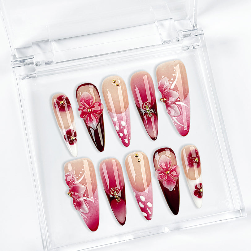 pink black nail designs long stiletto nude pink press-on nails with flower accents and French tip detail