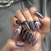purple flower nails medium almond press-on nails in black and deep purple with subtle floral accents cool winter holiday style