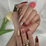 red flower nails medium almond press-on nails with nude base red tips yellow accents floral details and french tip design prom summer style