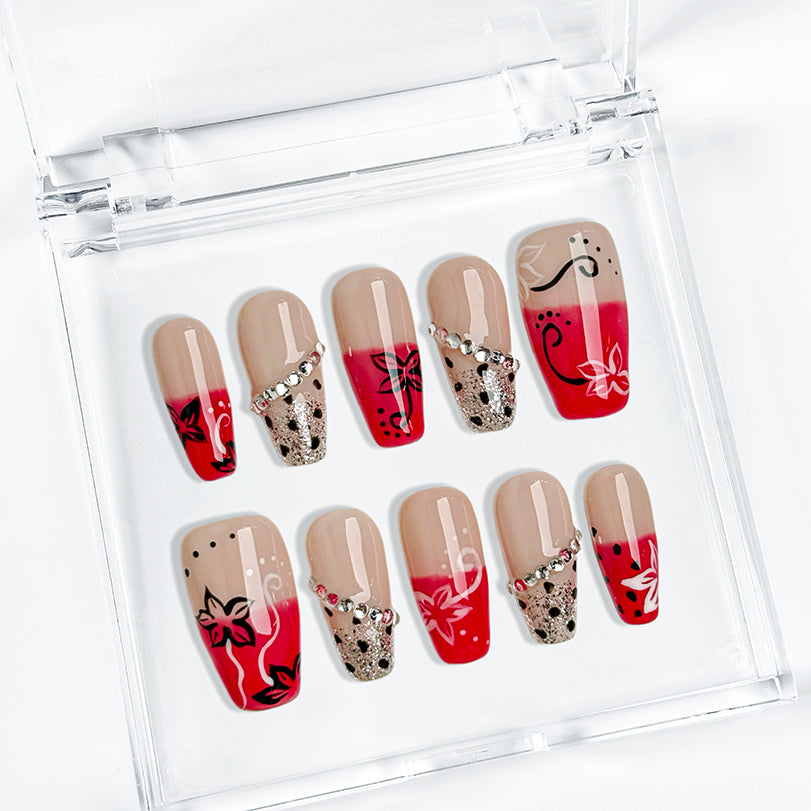 red flower nails medium square press-on nails with nude base red ombre tips floral accents and sparkle luxury summer wedding style