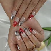 red flower nails medium square press-on nails with nude base red ombre tips floral accents and sparkle luxury summer wedding style