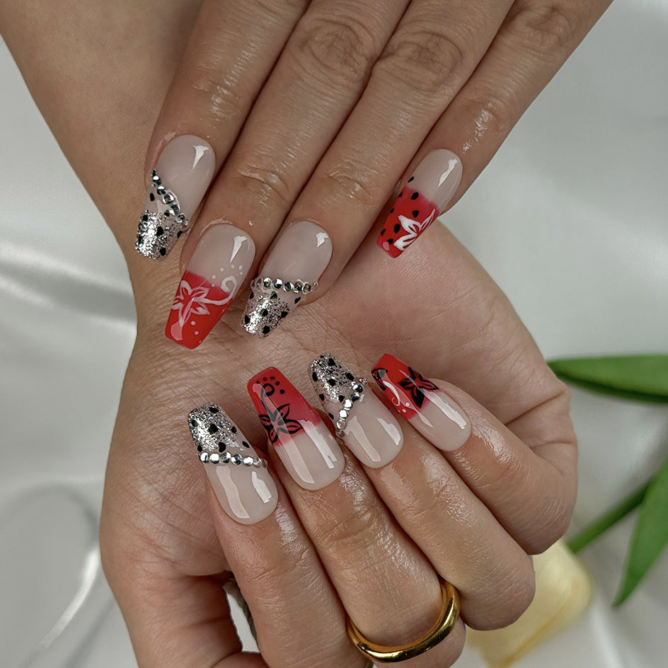 red flower nails medium square press-on nails with nude base red ombre tips floral accents and sparkle luxury summer wedding style