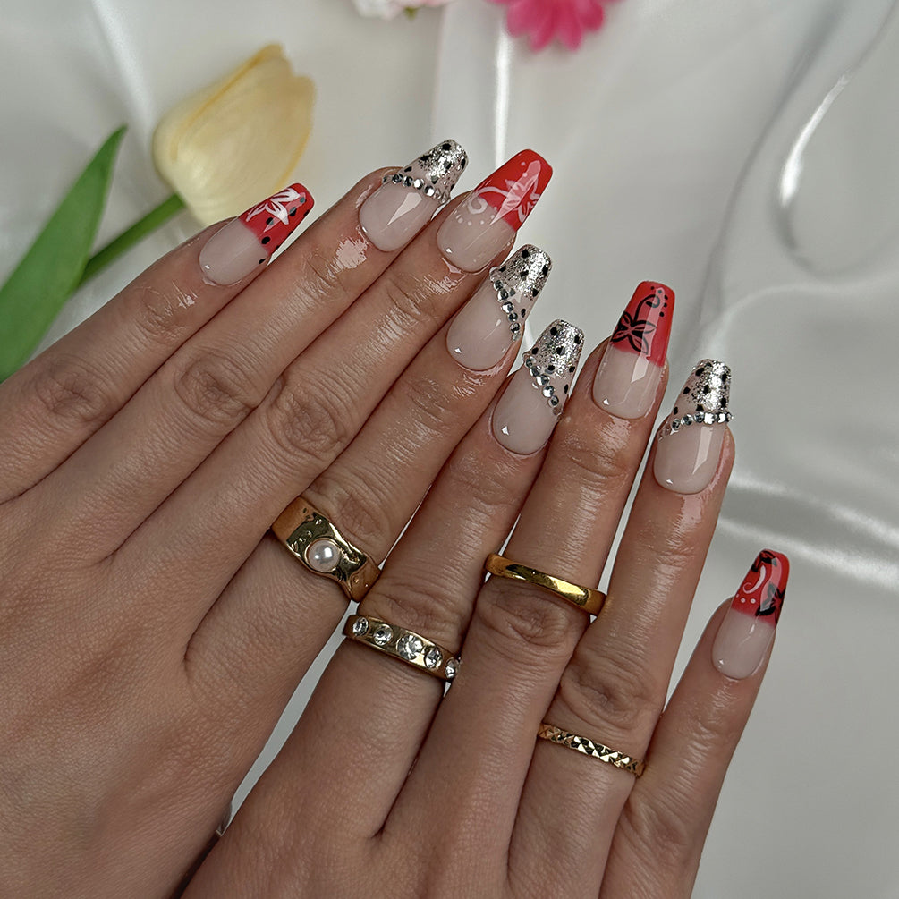 red flower nails medium square press-on nails with nude base red ombre tips floral accents and sparkle luxury summer wedding style