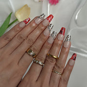 red flower nails medium square press-on nails with nude base red ombre tips floral accents and sparkle luxury summer wedding style