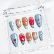 royal blue nails medium almond press-on nails with blue and pink floral accents and french tips for summer beach party and prom style