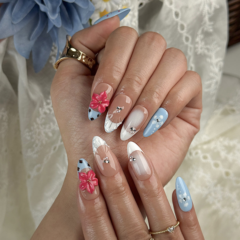 royal blue nails medium almond press-on nails with blue and pink floral accents and french tips for summer beach party and prom style