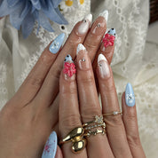royal blue nails medium almond press-on nails with blue and pink floral accents and french tips for summer beach party and prom style